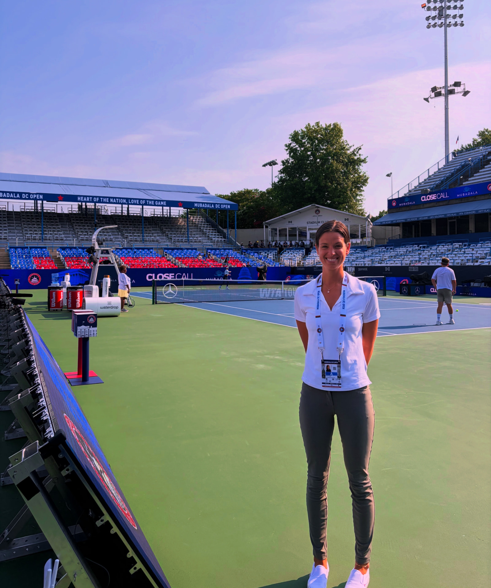 Nicole Kruger standing courtside at the Mubadala Citi DC Open wearing her tournament credential